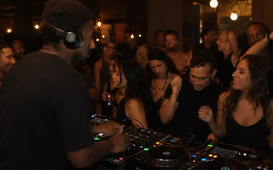 A DJ playing to a full dance floor.